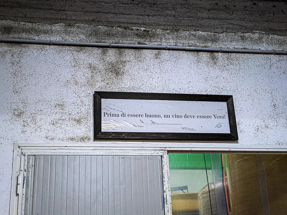 A plaque reads “Before being good, a wine should be Real!” in Frank Cornelissen Winery (Photo: Sylvia Ba)